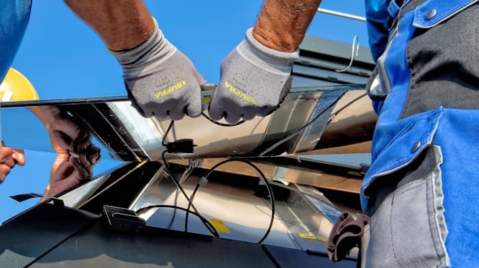 Technicians connecting a solar panel