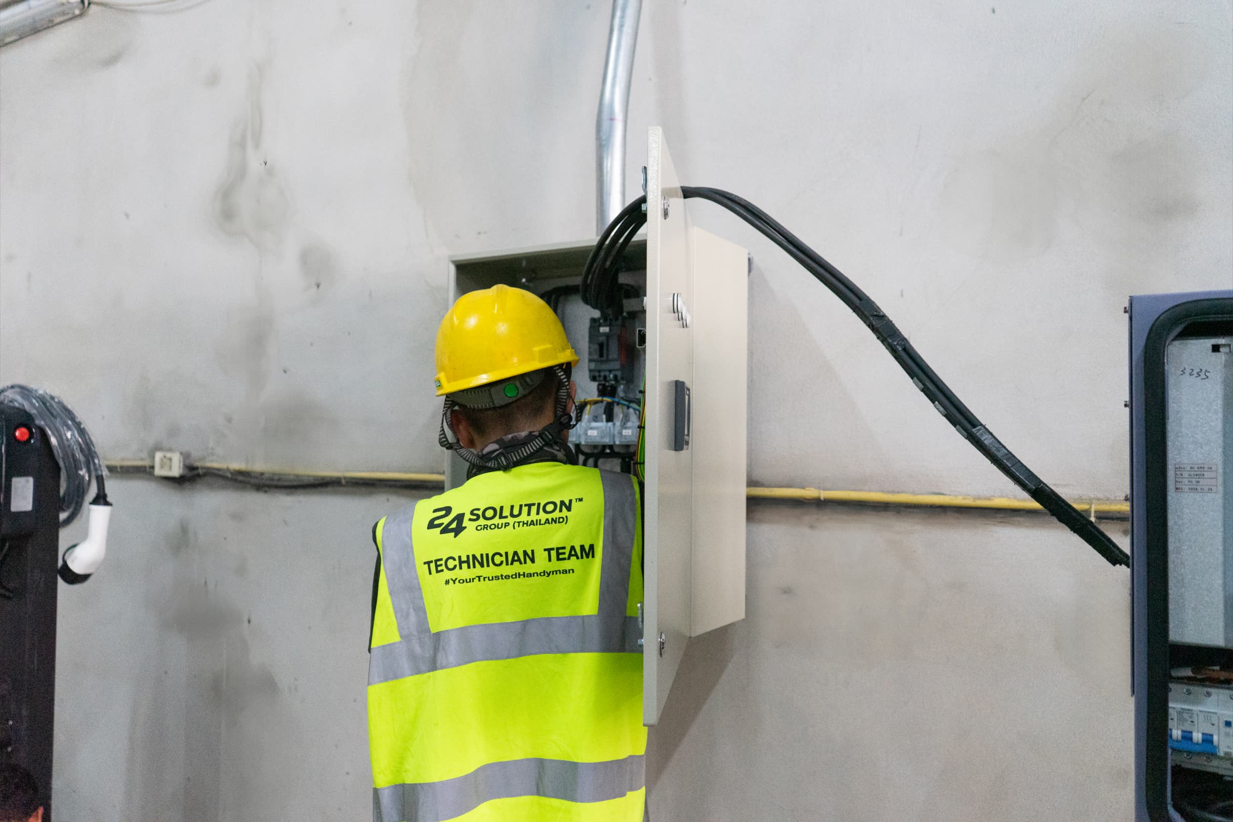 A maintenance technician servicing EV charging equipment