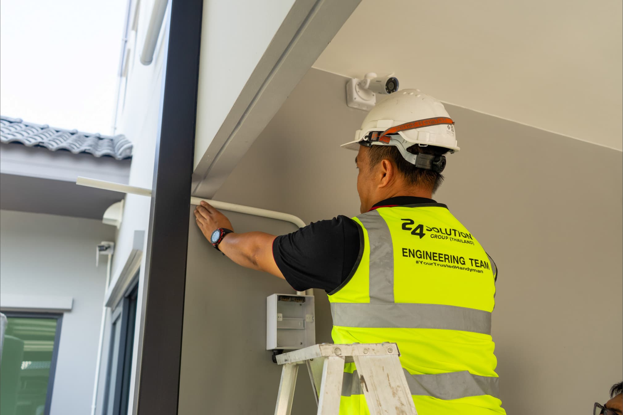 An engineer installing electrical conduit